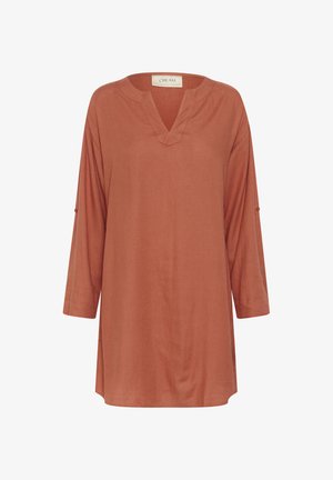 Tunique couleur rouille avec un col en V, des manches trois-quarts et une coupe décontractée. Fabriquée en tissu doux avec une texture lisse. Sans motifs ni accents.