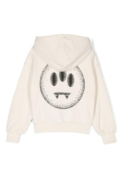 Hættetrøje i off-white med et stort sort grafik af et ansigt med tre øjne og tænder på ryggen. Blødt, tekstureret stof.
