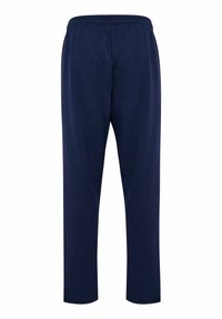 Granatowe spodnie dresowe z elastycznym pasem, zwężanymi nogawkami i miękką teksturą, bez widocznych logo i wzorów.
