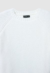 Weißer Rippstrickpullover mit Rundhalsausschnitt und sichtbarem schwarzem Etikett mit der Aufschrift "CALLIOPE S" im Kragen.