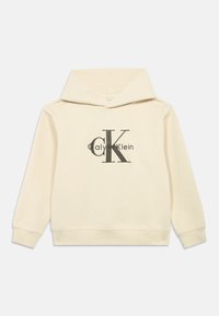 Krémová mikina s velkou přední kapsou, kapucí na šňůrku a černým logem Calvin Klein potištěným na hrudi. Měkká textilie.