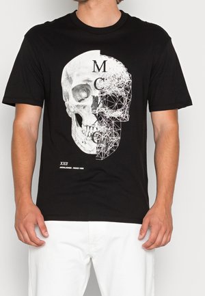 Czarna bawełniana koszulka z grafiką czaszki podzielonej na dwa wzory: realistyczna czaszka z jednej strony i wzór geometryczny z drugiej.