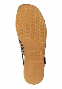 Suola di scarpa con stampa leopardata e fondo in gomma beige testurizzata. Presenta una cinghia nera e un'impronta del logo sul lato posteriore.