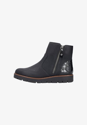 Bottines noires à talons avec une finition en cuir texturé, zip latéral et un accent brillant en motif crocodile au talon. Semelle en caoutchouc épaisse.