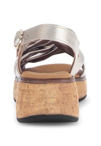 Metallic silver strappy sandals with cork platform, featuring a rounded toe and an adjustable buckle strap on the ankle for secure fit.