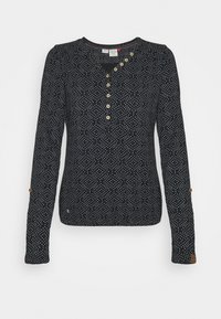 Schwarzes Langarmshirt mit weißen Pünktchen, V-Ausschnitt mit Holzknöpfen, gerafften Schultern und einem kleinen Logo-Akzent am Saum.