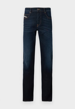 Donkerblauwe jeans in een klassieke rechte pasvorm. Gemaakt van denim, met oranje stiksels, vijf zakken en een gulp met knopen.