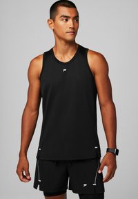 Black athletic tank top made of breathable fabric, featuring a round neckline and a small logo at chest. Paired with black shorts.