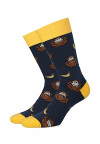 Niebieskie skarpetki z żółtymi mankietami mają powtarzający się wzór małp oraz akcenty bananowe, wykonane są z miękkiego materiału, zapewniającego wygodne dopasowanie.
