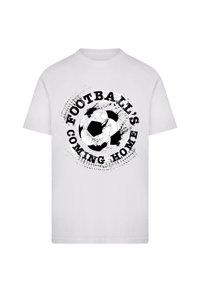 White t-shirt featuring a black graphic of a soccer ball with the text "FOOTBALL'S COMING HOME" in a distressed style around it.