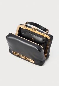 Black leather handbag with gold frame and clasp, "LOVE MOSCHINO" gold lettering on front, open showing interior pocket and handle.