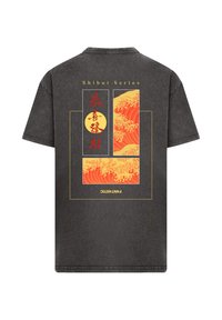 Black cotton t-shirt featuring a colorful wave pattern graphic on the back, with red, yellow, and orange colors framed in gold lines.