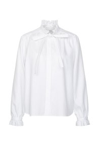 Blouse blanche à manches longues avec col et poignets volantés, avec un détail nœud papillon au niveau du cou et une coupe ample.