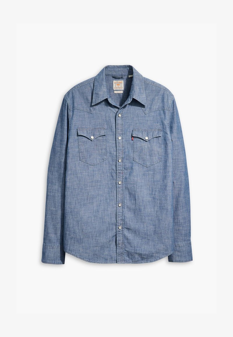 Heleheline šambri särg, millel on pikad varrukad, terav krae, kaks rinna taskut ja hõbedased nööbid. Sile tekstuur koos klassikalise disainiga.