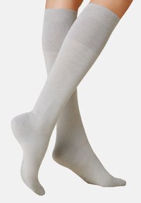 Hellgraue knielange Socken aus glattem, dehnbarem Stoff, mit einem gerippten Bündchen und nahtloser Zehenpartie für Komfort und perfekten Sitz.