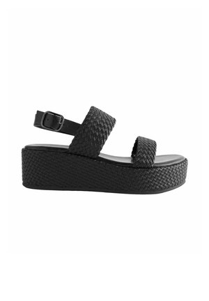 Sandales noires à plateforme avec texture tissée, deux larges sangles et une sangle de cheville adjustable. Fabriquées en matériau synthétique avec une semelle lisse.
