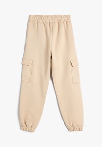 Beige sweatpants med elastisk talje og afsluttede ankler, der har to sidelommer og en struktureret stoffinish.