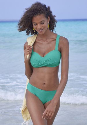 Turquoise bikini set with a bra-style top featuring wide straps and ruched detailing, paired with matching mid-rise briefs. Texture is smooth.