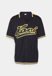 Camicia nera a maniche corte con bottoni, rifinita con profili gialli e bianchi e la scritta gialla "Kani" sul petto.