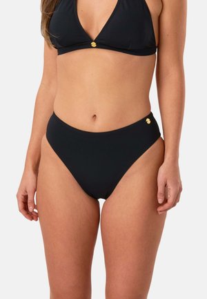 Kobieta nosząca czarne, bikini z wysokim stanem oraz pasujący top bikini z małymi złotymi akcentami logo na każdej części.