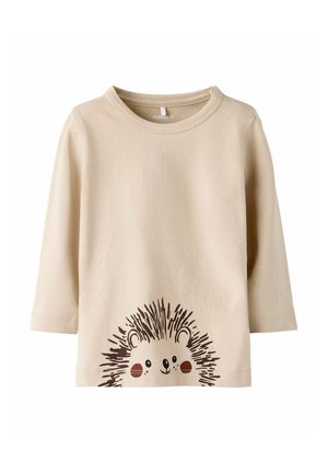 Beige long-sleeve shirt made of cotton, featuring a graphic of a hedgehog with spiky details and rosy cheeks printed on the front.
