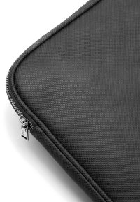 Black textured laptop sleeve featuring a metallic zipper and a sleek, rounded edge design for minimalistic style.