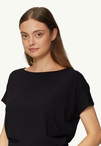 Black short-sleeve top with a wide, rounded neckline. Soft fabric with a smooth texture, featuring a relaxed fit.