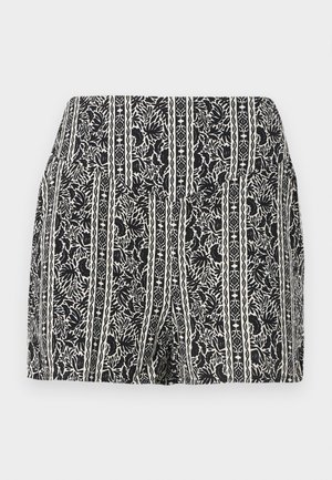 Pantaloni scurți alb-negru cu talie înaltă, având modele verticale de flori și frunze și un waistband ajustat pe un fundal simplu.