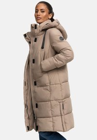 Beige puffer jacket with a hood, quilted texture, black accents, side pockets, full zip, and drawstrings on the hood.