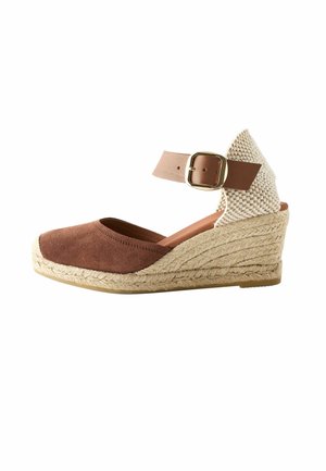 Brown suede wedge shoe with an ankle strap, featuring a woven fabric back and a jute-wrapped sole. Buckle closure at ankle.