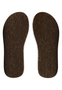 Semelles de chaussures brunes présentant une surface texturée avec des motifs géométriques, des bords arrondis et des contours prononcés pour le confort et le soutien.