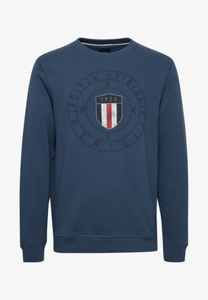 Tengerészkék, pamut keverékből készült pulóver. Kerek nyakkivágással, bordázott mandzsettákkal és középen elhelyezett logó grafikával rendelkezik, amelyen egy pajzs és az "1924" évszám látható.