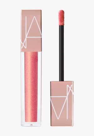 Lucidalabbra in un tubo trasparente con una formula scintillante rosa, caratterizzato da un tappo rettangolare color oro rosa e un applicatore nero.