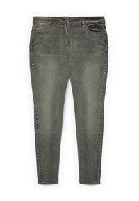 Jeans de mezclilla gris con corte slim, que presentan adornos de tachuelas a lo largo de las costuras laterales y un diseño tradicional de cinco bolsillos.