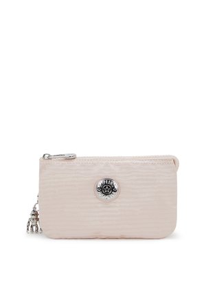 Textured light pink compact pouch with a zip closure, featuring a silver circular logo and a charm on the zipper pull.
