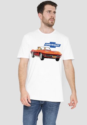 White t-shirt featuring a colorful graphic of a red Chevrolet convertible with two passengers and the "Chevrolet" logo above.