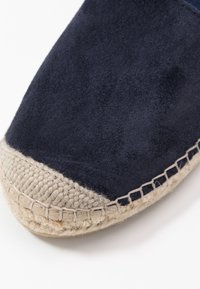 Navy sametové espadrilky s konopnou jute podešví, s tkanou texturou a kontrastním béžovým špičkou s prošitím.