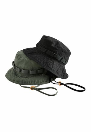 Two fabric bucket hats, one black and one dark green, each with a chin strap and stitched band around the crown.