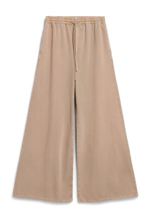 Beige weite Hosen mit elastischem Bund und Kordelzug. Weicher Stoff, glatte Textur und lässige Passform mit seitlichen Taschen.