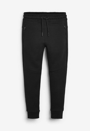 Schwarze Jogginghose aus weichem Baumwollmischgewebe. Verfügt über einen elastischen Bund, einen Kordelzug und zwei seitliche Reißverschlusstaschen. Konisch zulaufendes Bein.