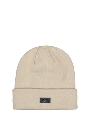 Beige knit beanie hat with folded cuff and small black rectangular logo patch on front center.