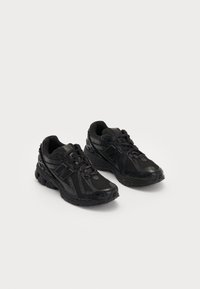 Black athletic shoes made of mesh and synthetic materials. Features a cushioned sole, textured patterns, and embossed branding on the side.