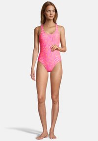 One-piece swimsuit in bright pink with a zebra print design. Features thin straps and a high cut leg. Smooth texture and fitted shape.