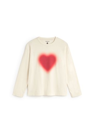Long-sleeve cream cotton t-shirt featuring a red spray-painted heart design at the center. Crew neck with a relaxed fit and stitched hem.