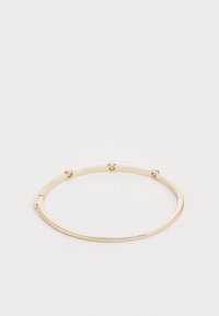Gold-tone bangle bracelet with a smooth finish, featuring small decorative studs and a simple, open design for easy wear.