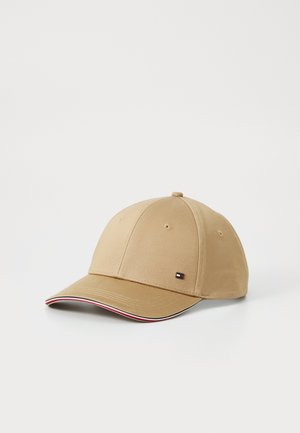 Beige baseball cap with small embroidered logo on front panel and red, white, and black trim along edge of curved brim.