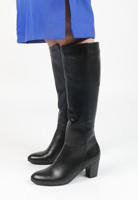 Black leather knee-high boots with a pointed toe and block heel, featuring a smooth texture and minimal stitching detail.