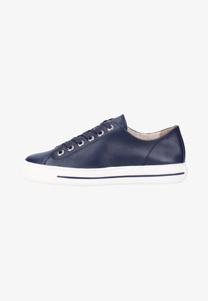 Zapatilla de cuero azul marino con suela de goma blanca, punta redonda y ojales plateados. Textura suave y diseño minimalista. Vista lateral.