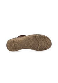 Brown sandal sole with textured grip, featuring various shapes and patterns. Durable rubber material with ridged design for traction.