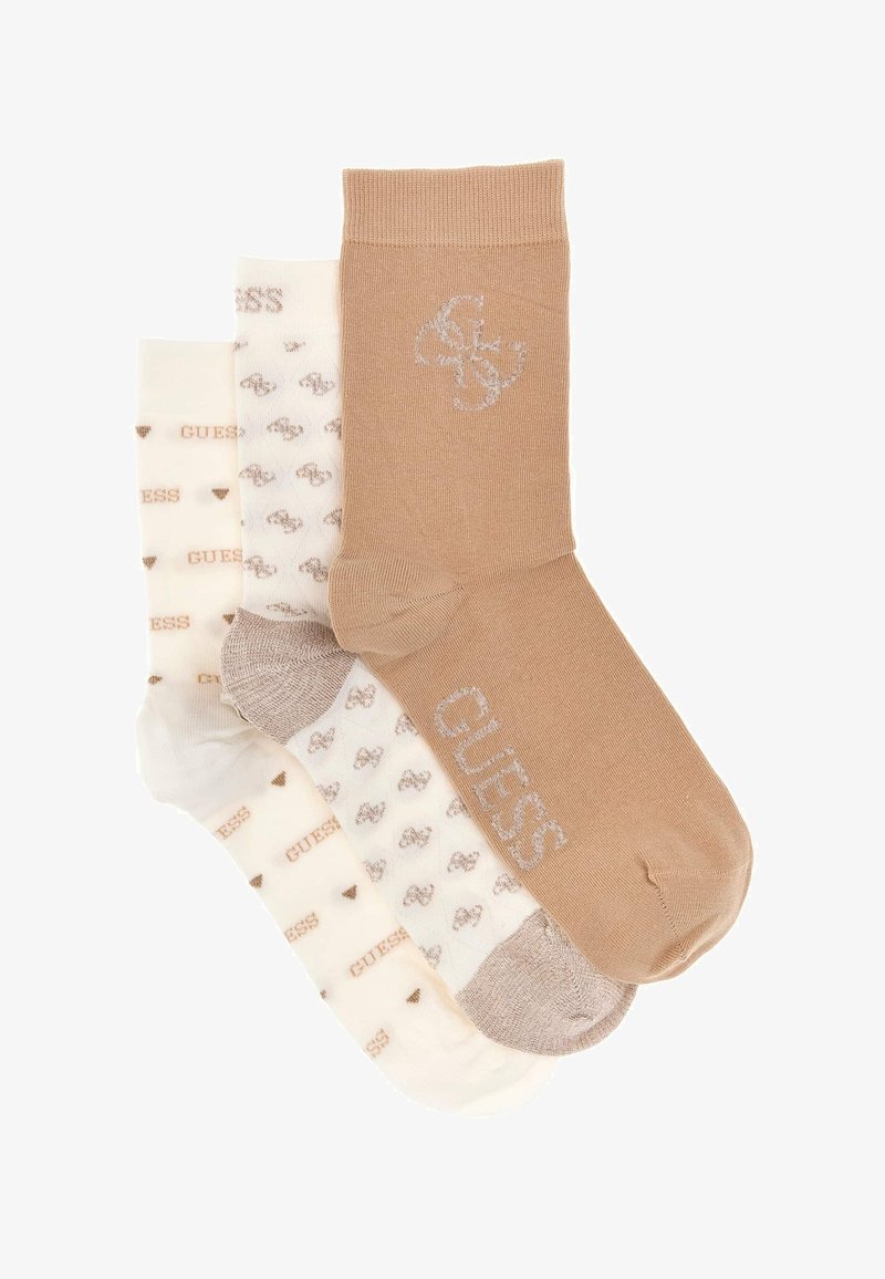Tričko ponožiek pozostávajúce z béžovej ponožky s logom, krémového páru srdiečok a krémového páru s textom "GUESS". Mäkka, zmes bavlny.